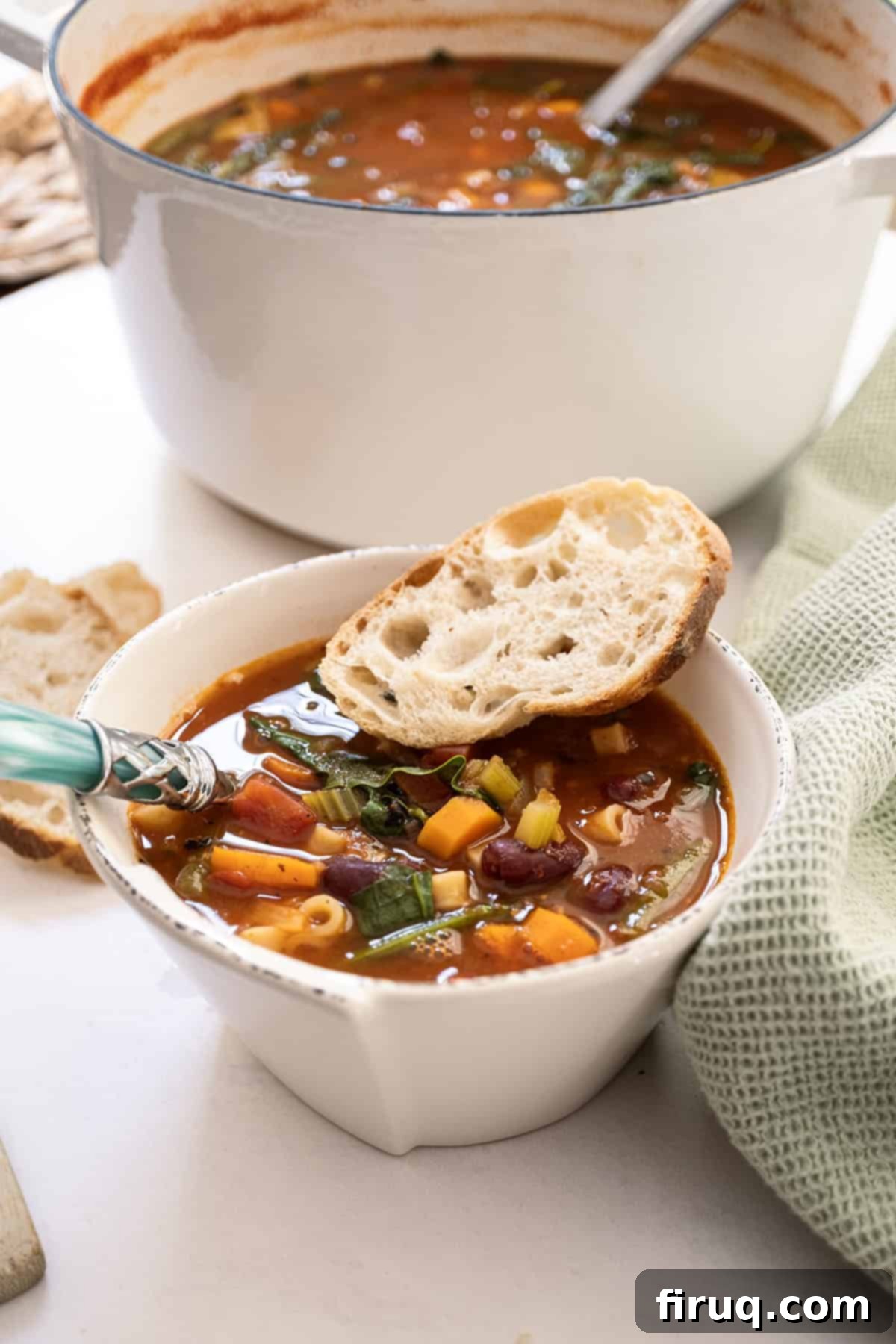 Authentic Italian Minestrone 2 A bowl of minestrone with a piece of Italian bread.