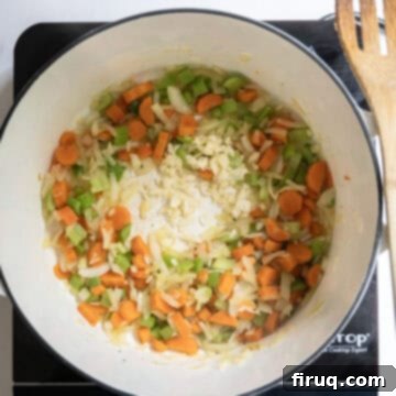 Authentic Italian Minestrone 4 Carrots, celery, and onion sauteing in a pot with garlic.