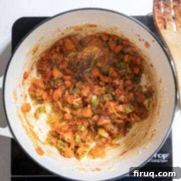 Authentic Italian Minestrone 5 Tomato paste mixed with sauteing vegetables to caramelize.