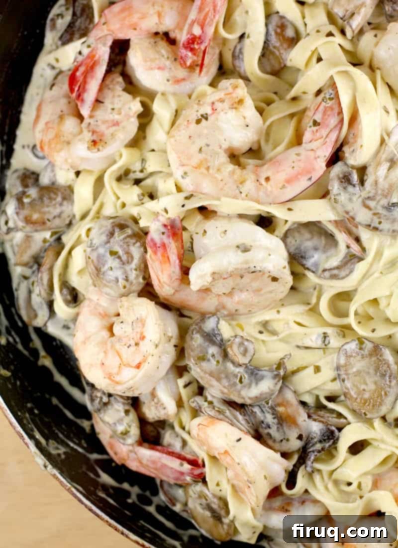 Luscious Creamy Pesto Shrimp Pasta 7 The finished shrimp linguine recipe showcased in the pan, with plump shrimp, savory mushrooms, and pasta generously coated in a rich, creamy sauce.
