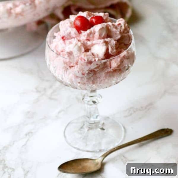 Tropical Cherry Ambrosia Tropical Cherry Ambrosia in a crystal glass bowl, showing its pink color and fluffy texture.