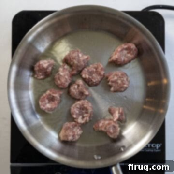 Sausage and Rapini Pasta 6 Pieces of ground sausage searing on a pan.