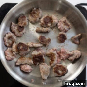 Sausage and Rapini Pasta 7 Pieces of ground sausage searing on a pan.