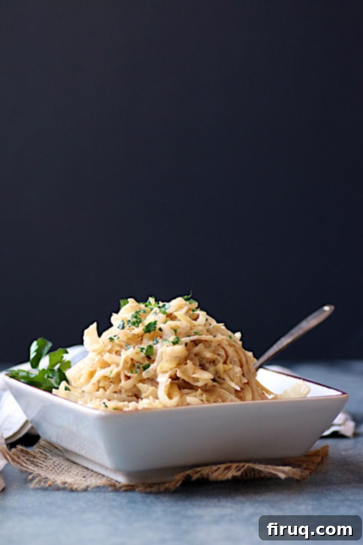 Creamy Caramelized Cabbage Dish Creamy Caramelized Cabbage in a square, off-white bowl, garnished with fresh herbs, showcasing its delicious texture.