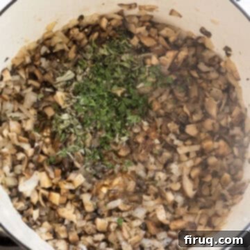 Velvety Mushroom Mascarpone Soup 5 Sauteed mushrooms and onions being seasoned with fresh herbs, spices, and Worcestershire sauce.