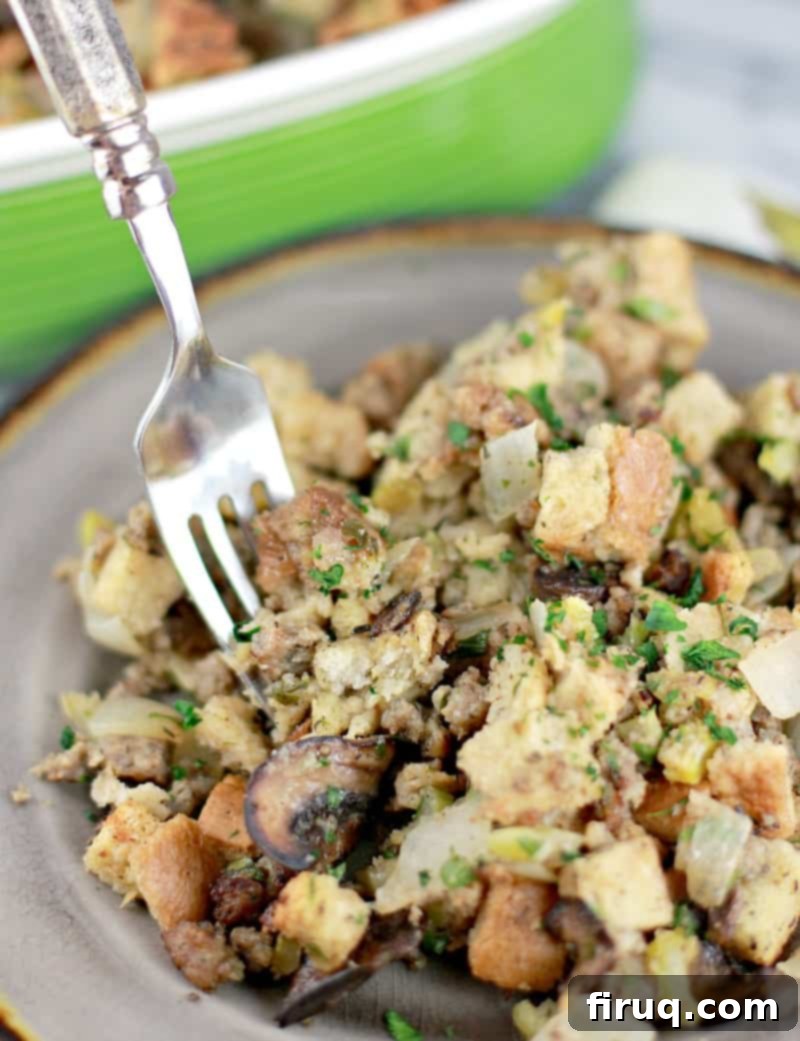 The Ultimate Holiday Stuffing 13 Close-up of stuffing on a plate with a fork, showing its moist and tender texture