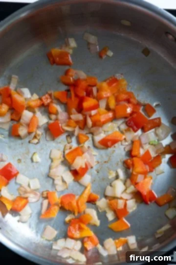 Velvety Red Pepper Sauce 5 Chopped shallots and red pepper sautéing in olive oil in a large pan until softened and fragrant.