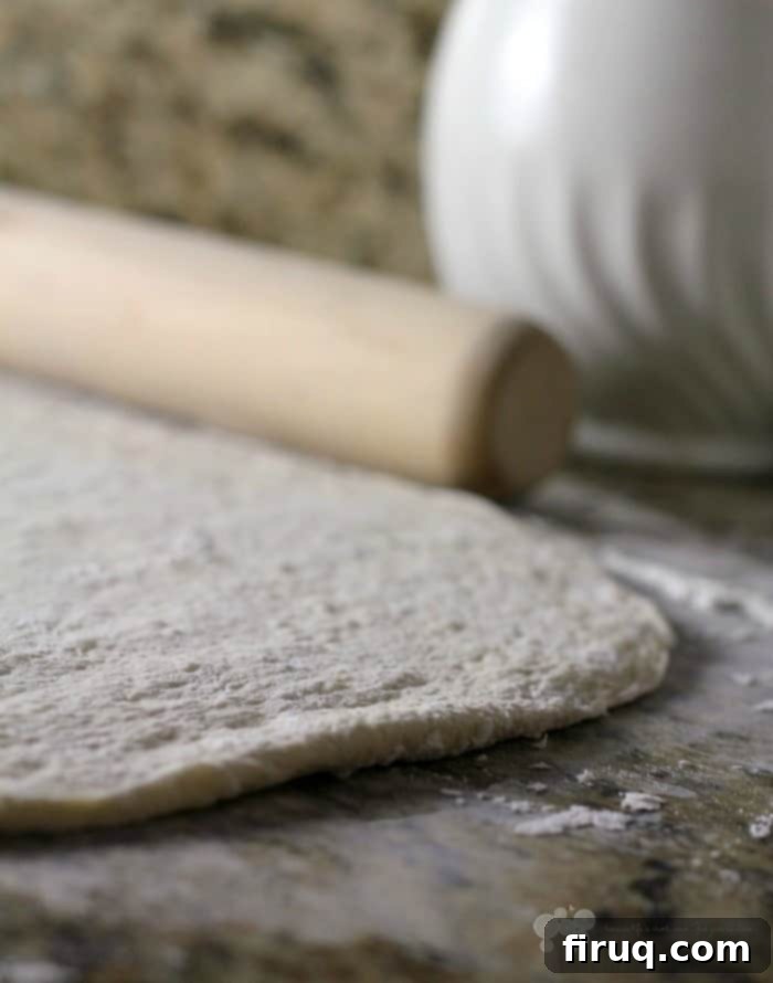 Cuba's Signature Slice 3 Raw pizza dough rolled out on a clean kitchen counter, ready for toppings.