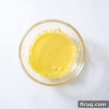 Emerald Dream Tiramisu 7 Fluffy, pale egg yolks beaten with sugar in a bowl.
