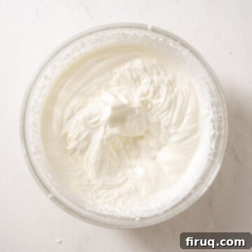Emerald Dream Tiramisu 9 Heavy cream beaten to stiff peaks, standing tall in a bowl.