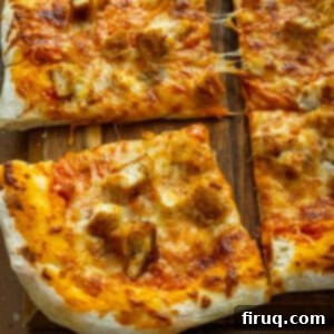 Creamy Vodka Chicken Pizza 12 Pizza cut into slices on the cutting board.