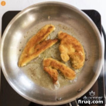 Creamy Vodka Chicken Pizza 5 Breaded chicken tenderloins frying in the saucepan in oil.