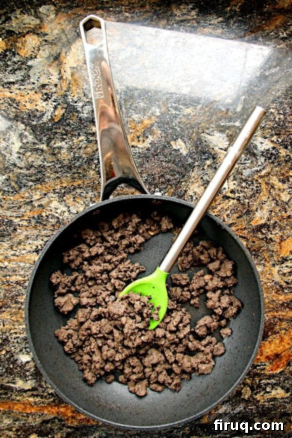 Cooked Ground Mushrooms for Blended Burgers Overhead photo of cooked ground mushrooms in a pan, resembling ground beef