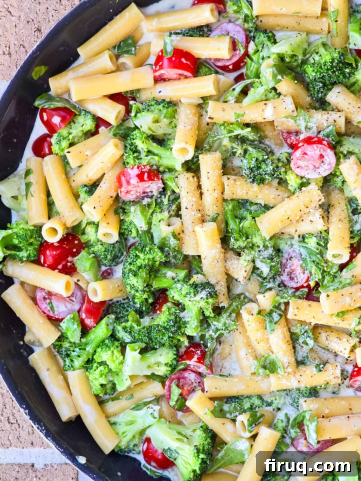 Lemony Creamy Pasta with Fresh Arugula and Broccoli 3 top down view into skillet with prepared arugula and broccoli pasta