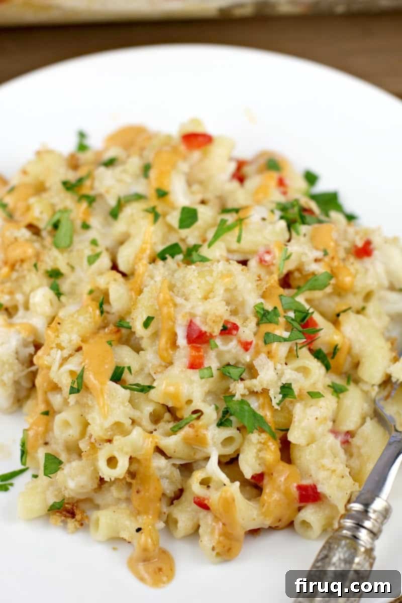 Decadent Crab Mac and Cheese 3 top down close view of plated recipe to show ingredient elements of pasta, crab, parsley, and remoulade