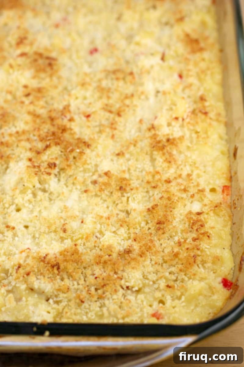 Decadent Crab Mac and Cheese 7 cooked casserole in bake dish before topping with remoulade and parsley