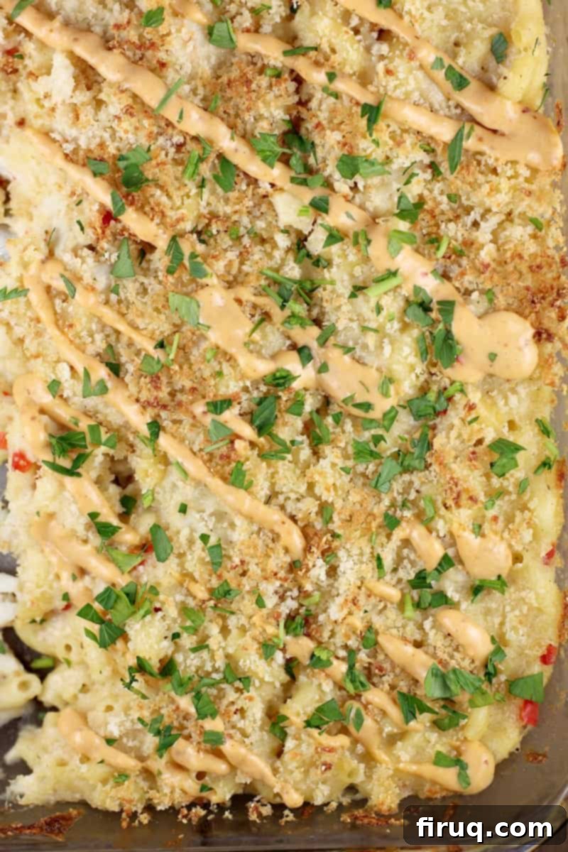 Decadent Crab Mac and Cheese 8 finished casserole in pyrex bake dish topped with remoulade and parsley