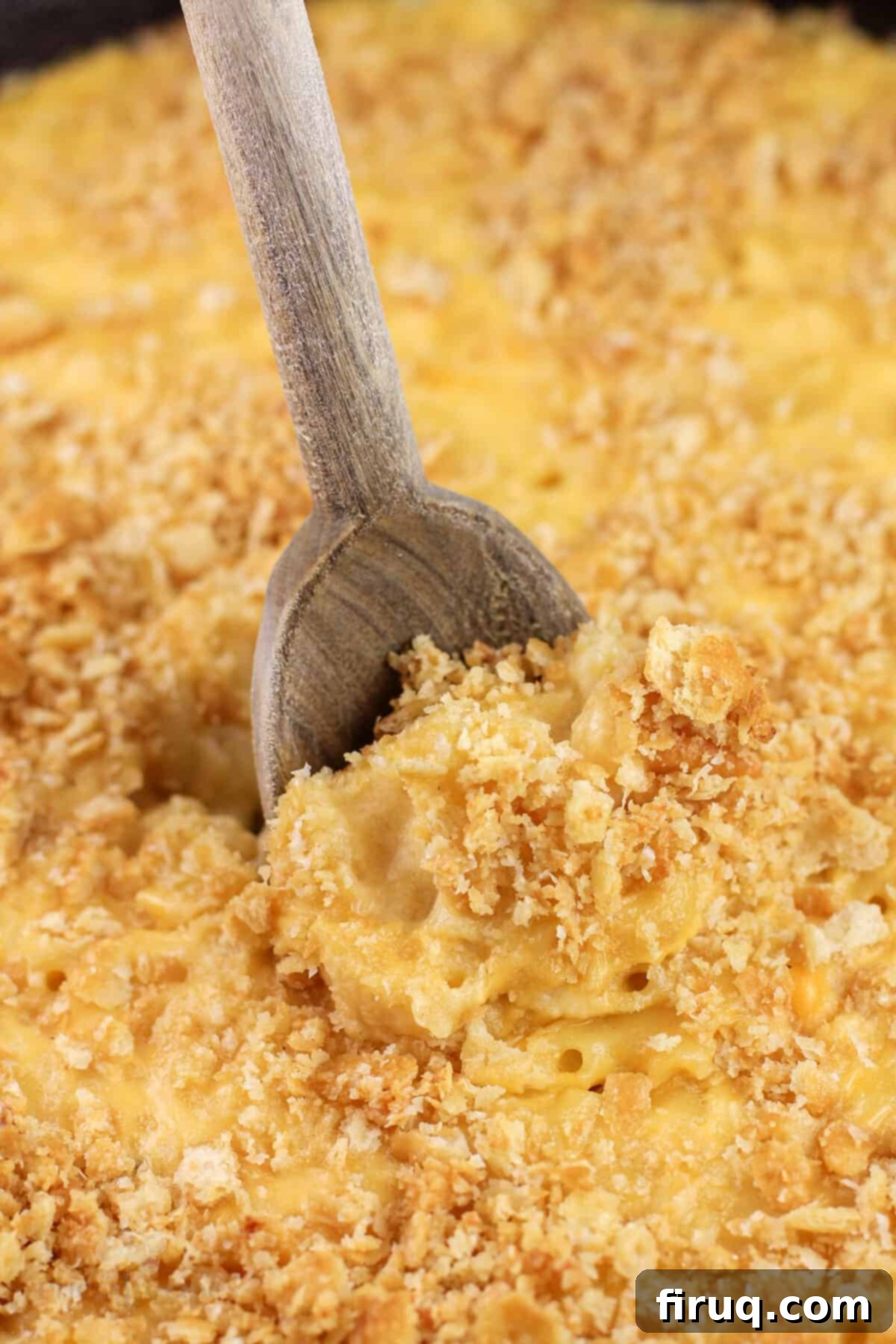 Classic Velvety Mac and Cheese 16 wood spoon inserted into mac n cheese