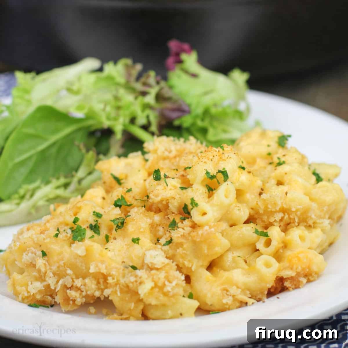 Classic Velvety Mac and Cheese 18 simple macaroni and cheese on white plate with salad; cast iron skillet in background