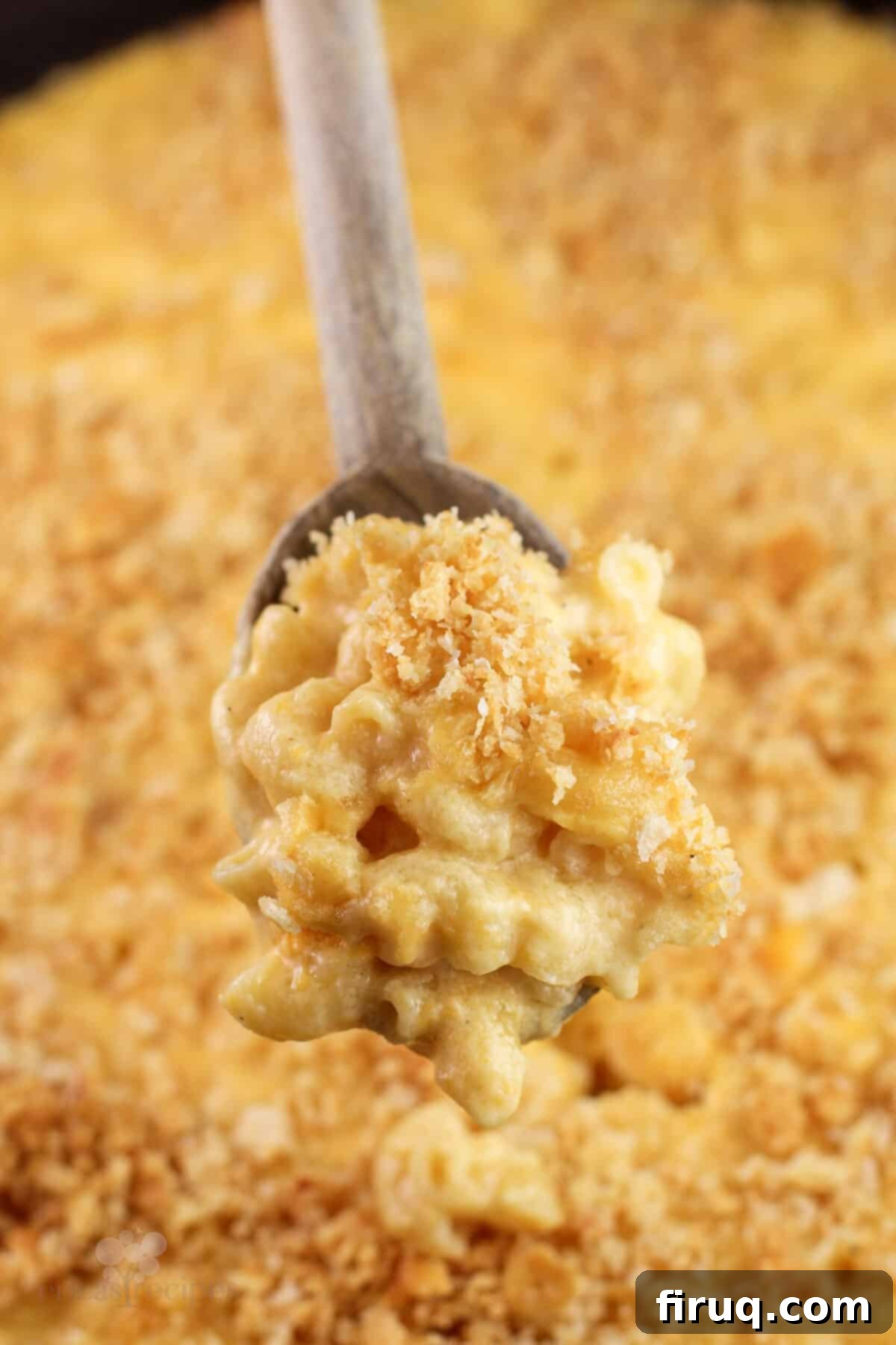 Classic Velvety Mac and Cheese 3 wood spoon holding creamy macaroni and cheese