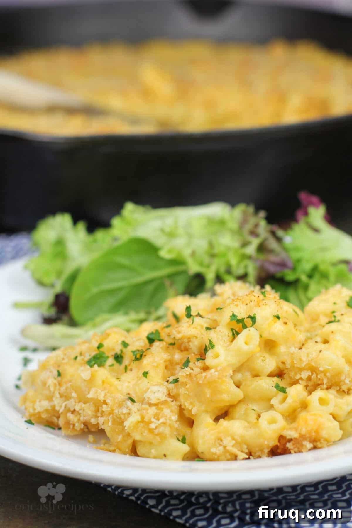 Classic Velvety Mac and Cheese 4 portion of macaroni and cheese on white plate with salad