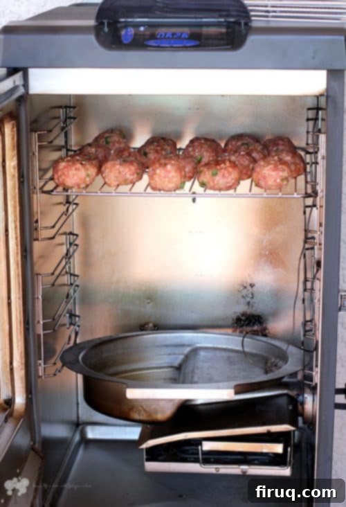Fiery Smoked Pork Bombs with Melted Jalapeño Cheese 4 A personal smoker at work, cooking Smoked Jalapeno Cheese-Stuffed Pork Balls