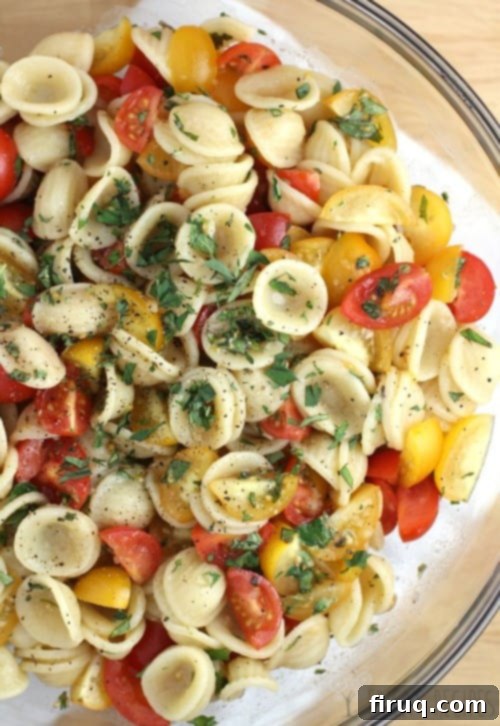 Effortless Salmon with Fresh Tomato Orecchiette 2 Close-up of raw tomato sauce ingredients: cherry tomatoes, garlic, oregano, and olive oil