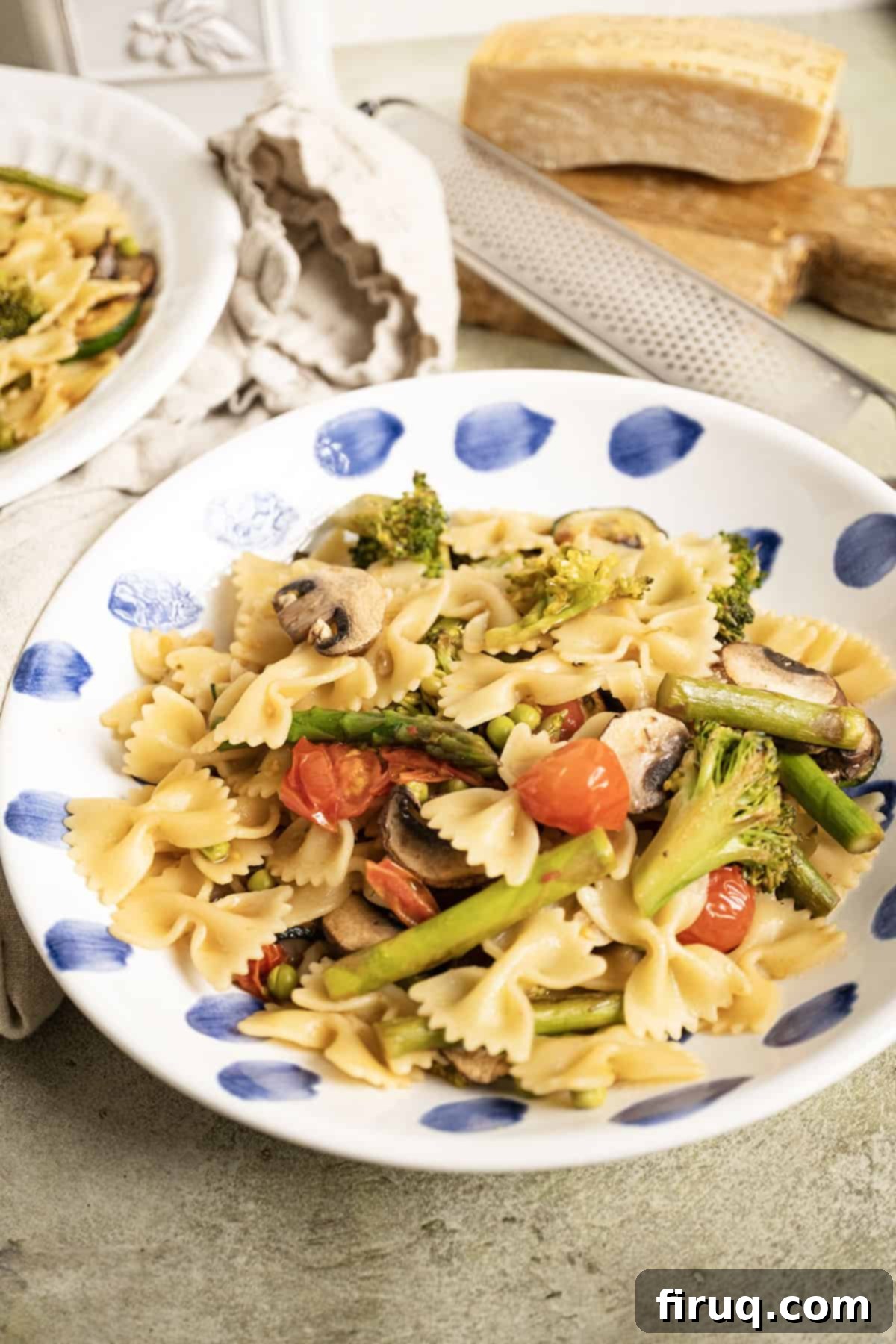 Broccoli and Asparagus Pasta Primavera 2 A bowl of pasta primavera, showcasing vibrant green broccoli and asparagus, with cherry tomatoes and a light sauce.