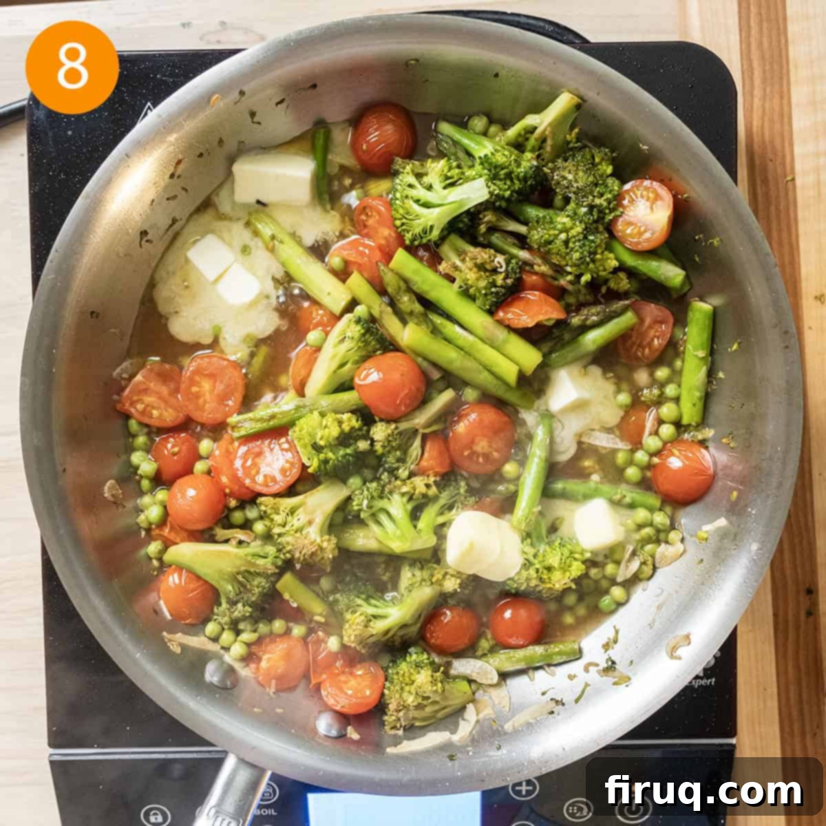 Broccoli and Asparagus Pasta Primavera 8 Stirring butter into the simmering garlic wine sauce.