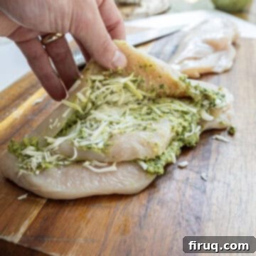 Perfect Pesto Stuffed Chicken 7 Pesto and mozzarella generously stuffed into the pockets of a butterflied chicken breast, ready for searing in a hot pan.