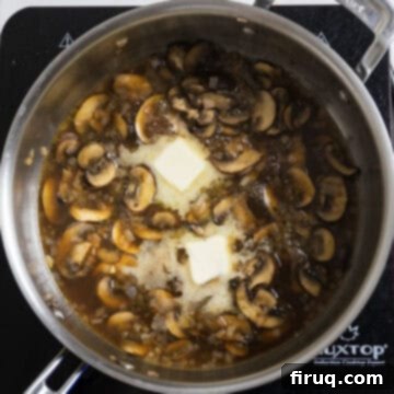 Rich Marsala Chicken with Sautéed Mushrooms 10 A pat of butter being added to the Marsala sauce in the pan, ready to be stirred in.