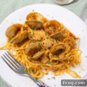 Robust Red Clam Linguine 12 linguine with clams in red sauce on a plate.