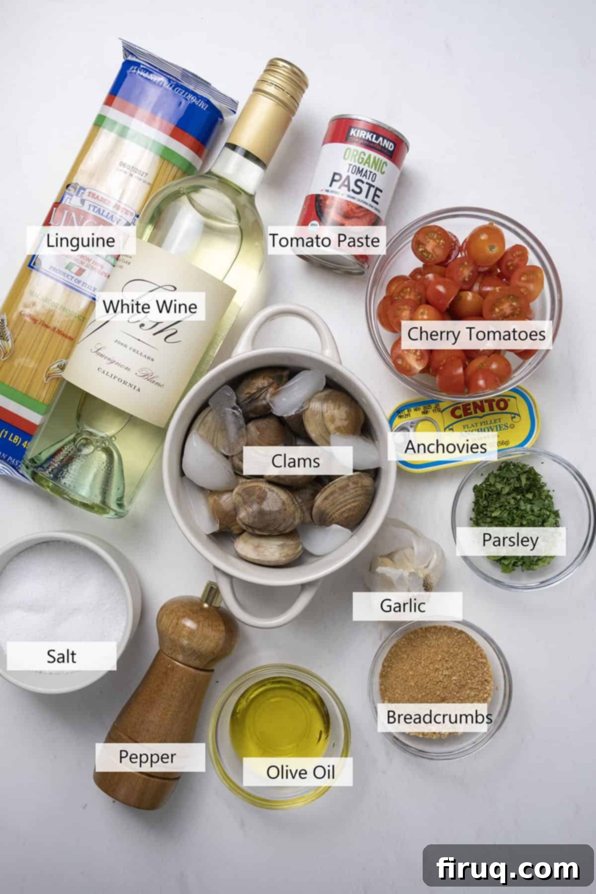 Robust Red Clam Linguine 3 A flat lay of fresh ingredients for the red clam sauce recipe, including cherry tomatoes, garlic, anchovies, and fresh clams.