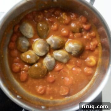 Robust Red Clam Linguine 8 Fresh, closed clams added to the simmering red clam sauce in a covered pot.