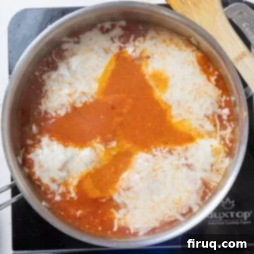 Ultimate Chicken Pizzaiola 11 Chicken cutlets in sauce generously topped with shredded mozzarella cheese, ready to melt.