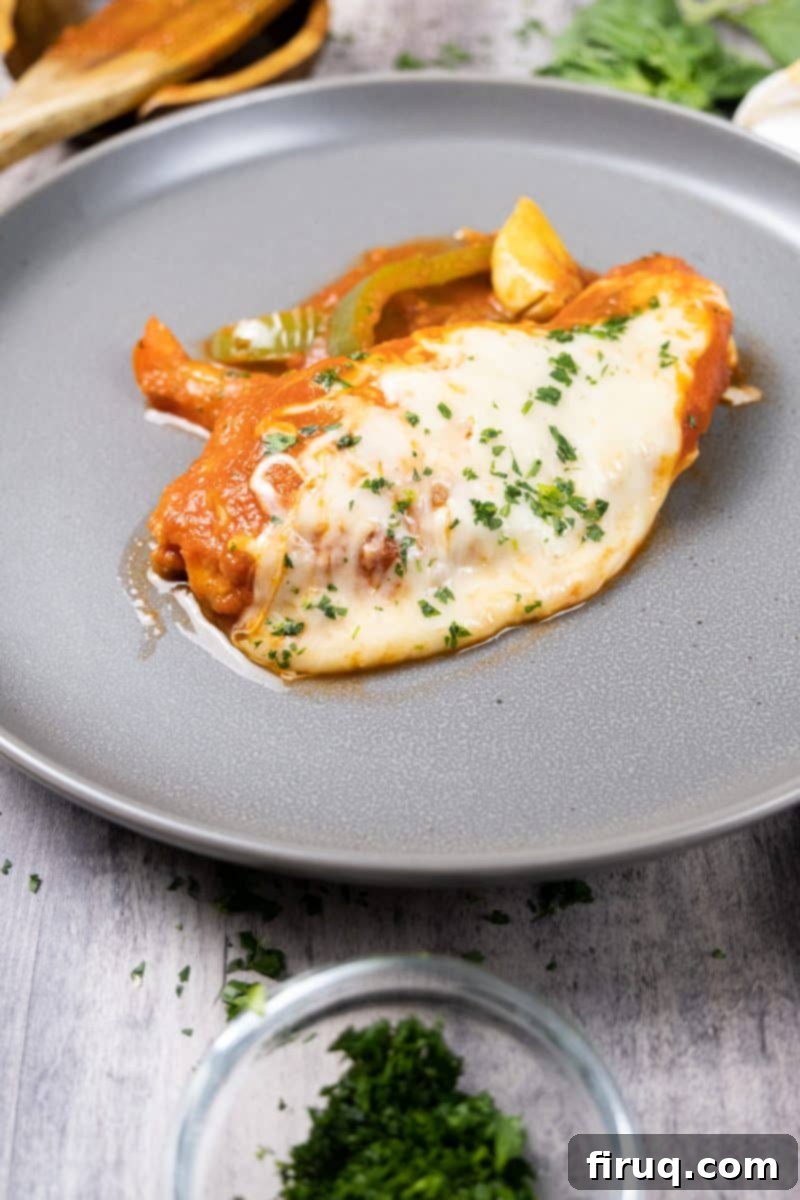 Ultimate Chicken Pizzaiola 12 A delicious serving of Chicken Pizzaiola, showcasing the tender chicken, vibrant tomato and pepper sauce, and melted cheese, ready to be enjoyed.