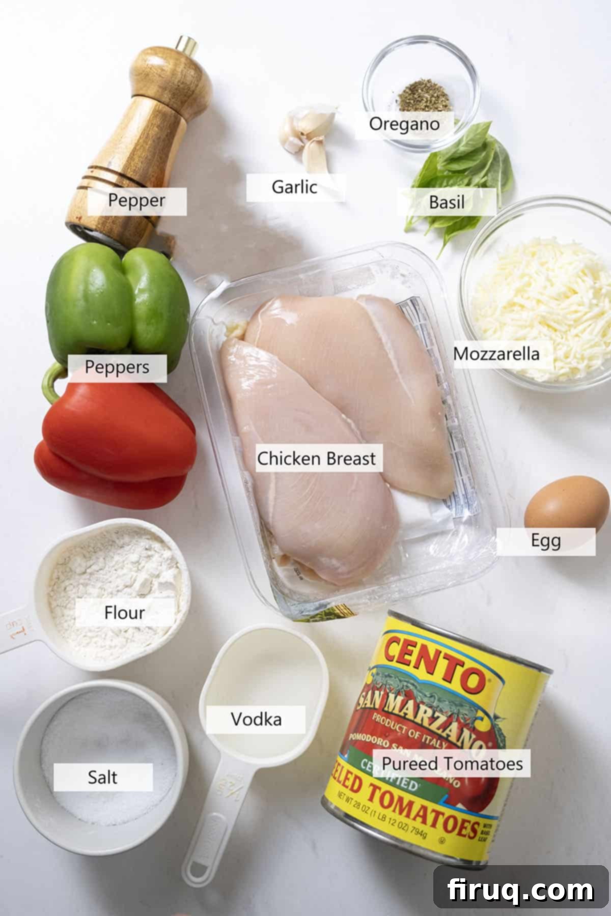 Ultimate Chicken Pizzaiola 3 A vibrant selection of fresh ingredients laid out for making Chicken Pizzaiola, including chicken breasts, canned tomatoes, colorful bell peppers, garlic cloves, mozzarella cheese, and fresh herbs.