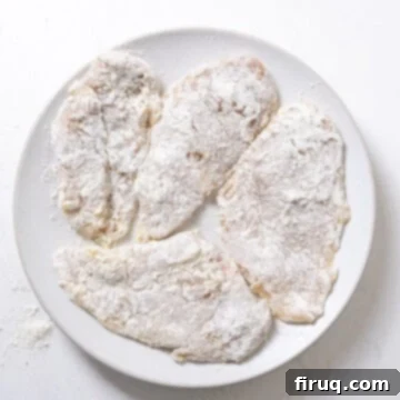 Ultimate Chicken Pizzaiola 5 Chicken breasts thoroughly dredged in flour, ready for frying.