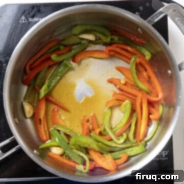 Ultimate Chicken Pizzaiola 8 Vodka being poured into the hot pan, deglazing the bottom and creating a thickened base.
