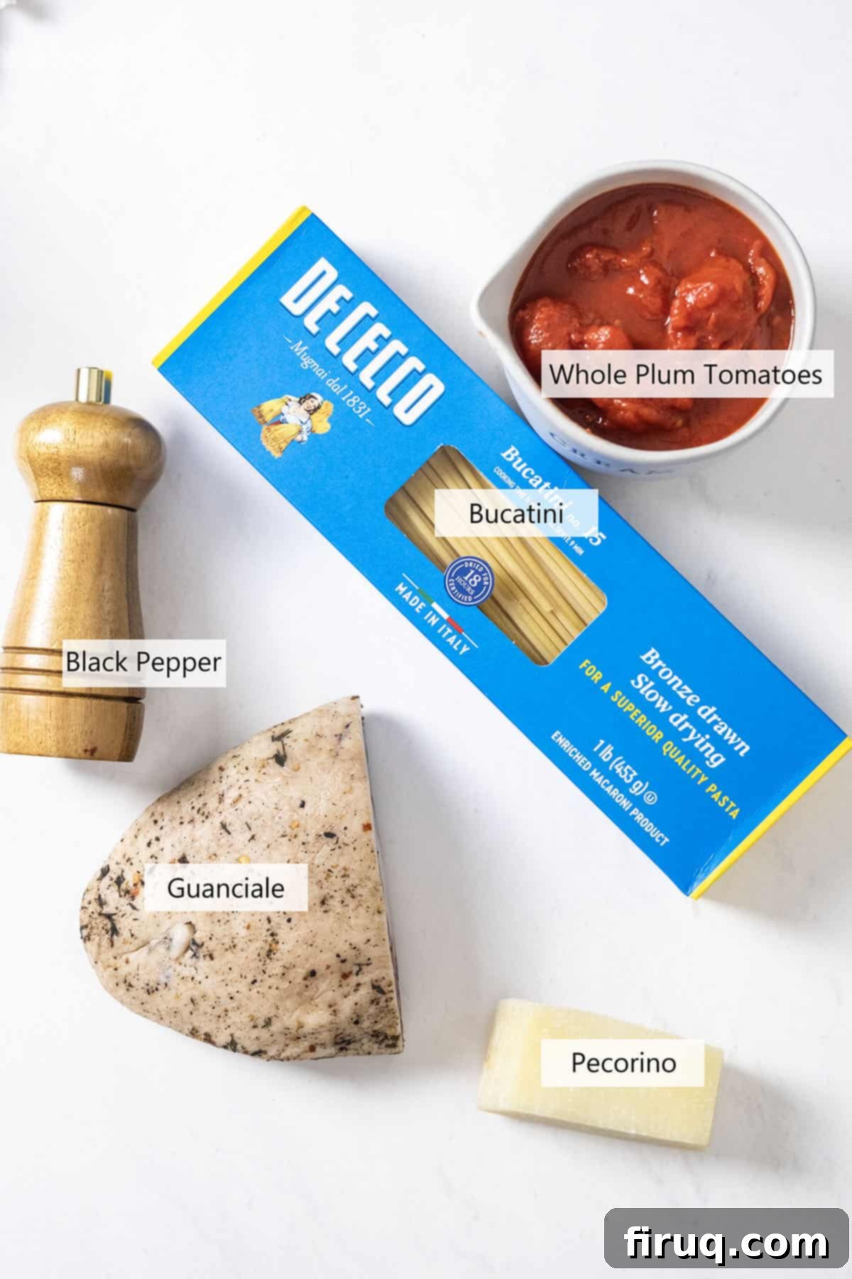 Bucatini Amatriciana 3 A visual guide to the core ingredients for Bucatini Amatriciana, including guanciale, Pecorino Romano, black pepper, peeled plum tomatoes, and bucatini pasta.