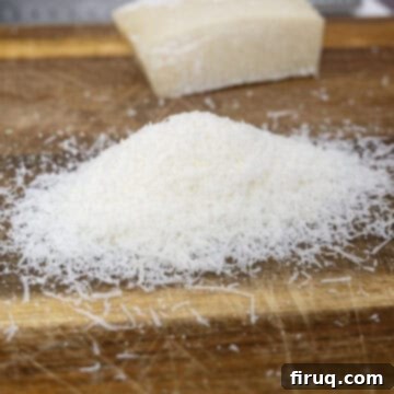 Bucatini Amatriciana 4 Finely grated Pecorino Romano cheese piled on a cutting board, ready for the pasta.