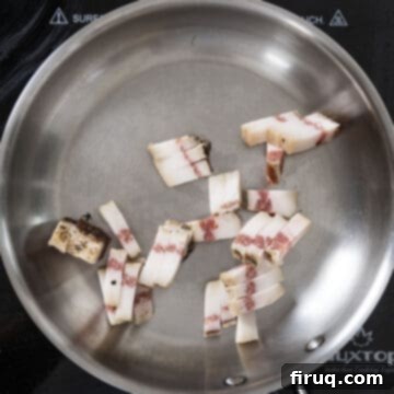 Bucatini Amatriciana 6 Strips of guanciale placed in a cold frying pan, awaiting the rendering process.