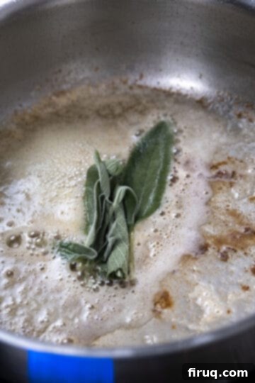 Elevated Chicken Saltimbocca 8 fresh sage leaves added to melting butter in a pan