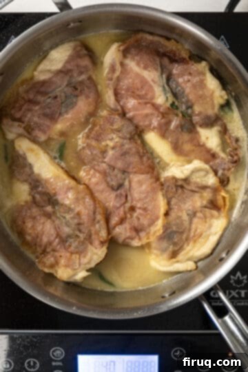 Elevated Chicken Saltimbocca 10 finishing chicken in the pan with the white wine sauce