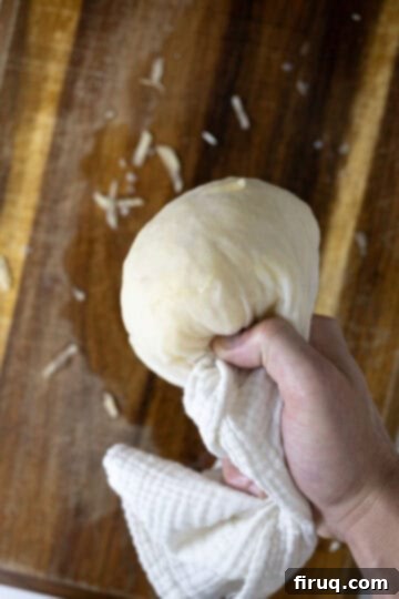 Your Italian Breakfast Sandwich 6 Drying grated potatoes using a cheesecloth to remove all moisture.