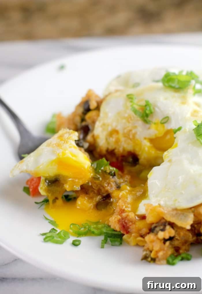 Set-It-And-Forget-It Quinoa Tamale Casserole 2 serving portion of prepared recipe on white plate with fork