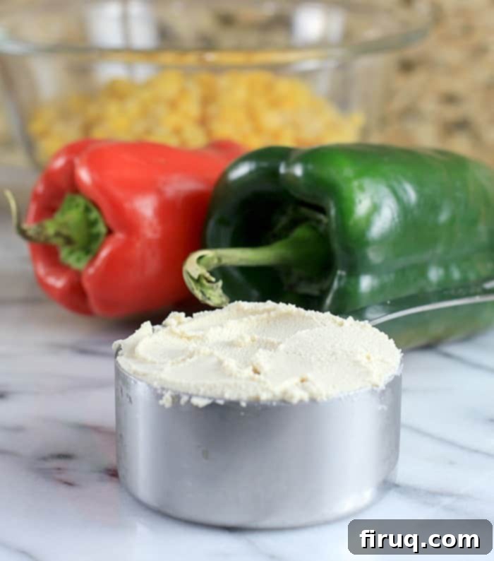 Set-It-And-Forget-It Quinoa Tamale Casserole 5 metal measuring cup with cashew ricotta; peppers in the background