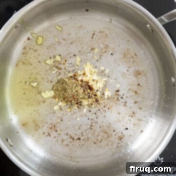 Pasta alla Norma: Sicilian Classic 6 Sauteing garlic and seasonings in a saucepan.