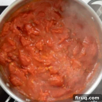 Pasta alla Norma: Sicilian Classic 8 Whole plum tomatoes broken down in saucepan.