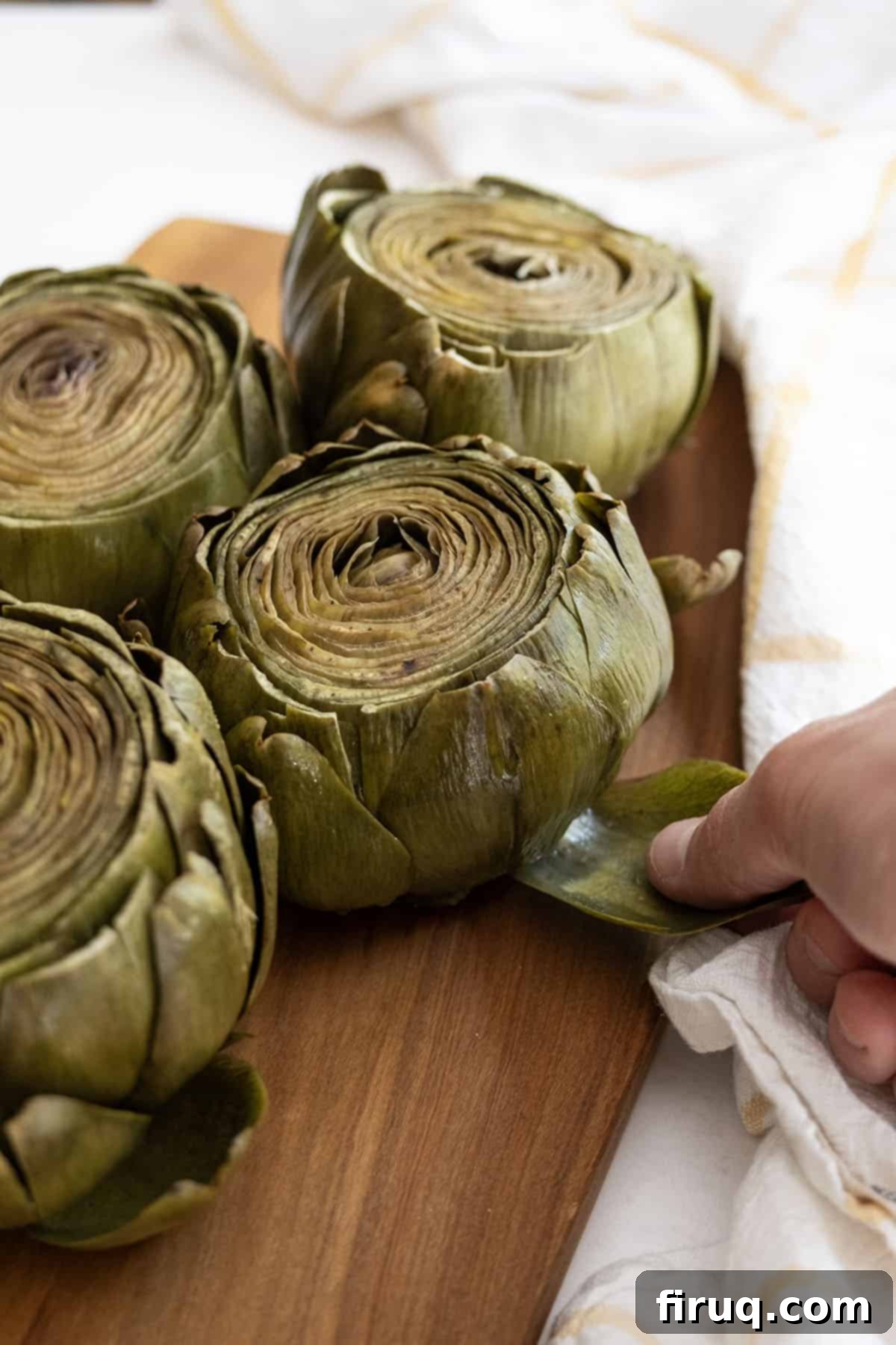 Perfectly Easy Steamed Artichokes 2 steamed artichokes, perfectly cooked and ready to eat, served on a plate
